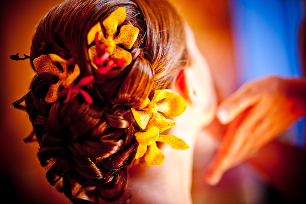 bride with a beautiful updo with yellow and orange floral accessories - photo by New Mexico based wedding photographers Twin Lens